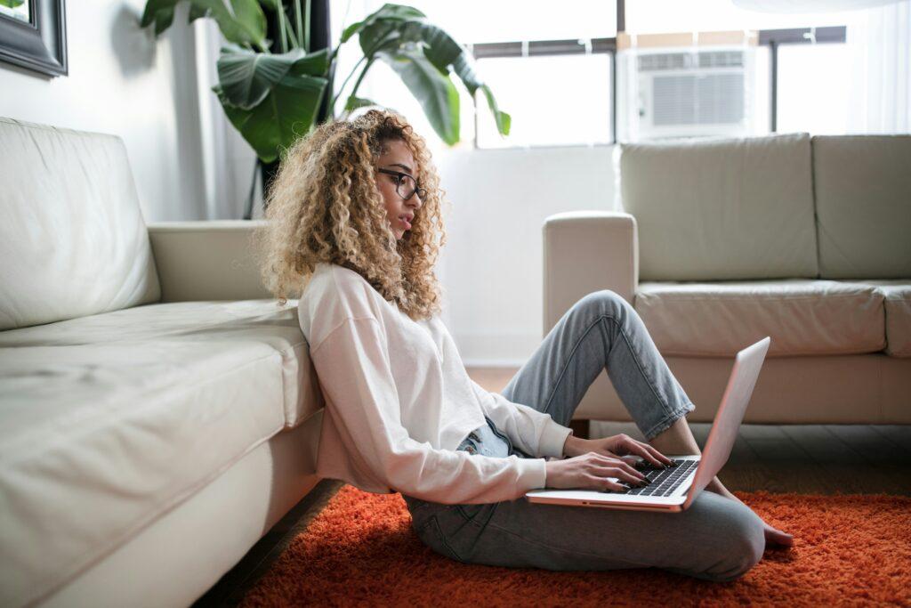 Young renter reviewing insurance policy on laptop in home — concept of filing a renters’ insurance claim